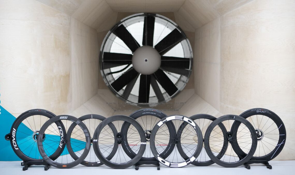 Nine front road bike wheels sit in front of the fan within a wind tunnel