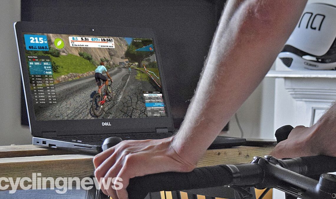 A cyclist on a smart trainer, with a Dell computer in front of him, with Zwift on the screen