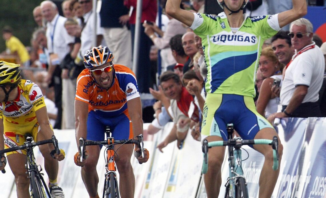 Italian Vincenzo Nibali (R) raises his a