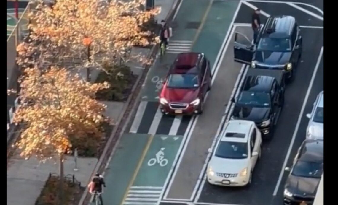 a car passes bikes in Paris in the bike lane