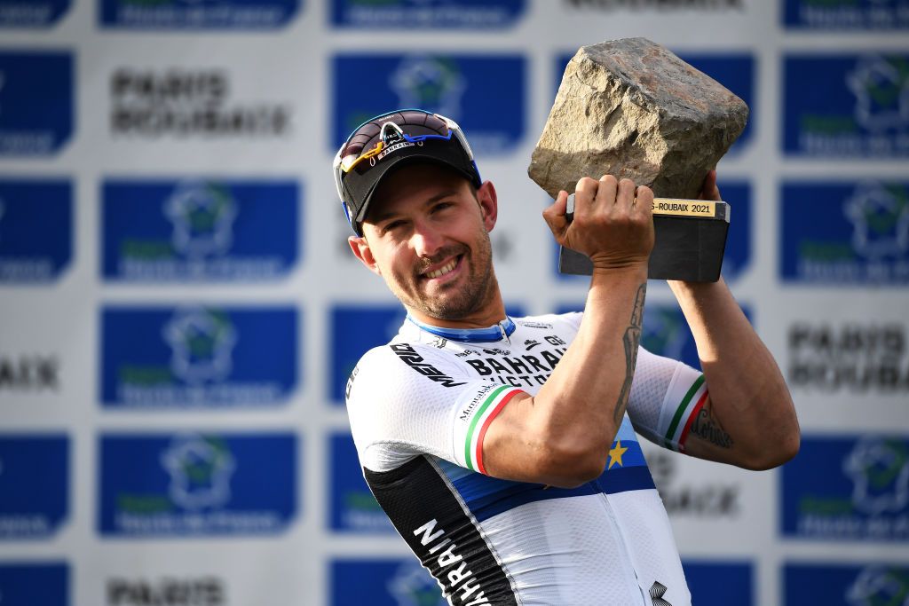 ROUBAIX FRANCE OCTOBER 03 Sonny Colbrelli of Italy and Team Bahrain Victorious celebrates winning the race and kisses his cobblestone trophy on the podium ceremony after the 118th ParisRoubaix 2021 Mens Eilte a 2577km race from Compigne to Roubaix ParisRoubaix on October 03 2021 in Roubaix France Photo by Tim de WaeleGetty Images