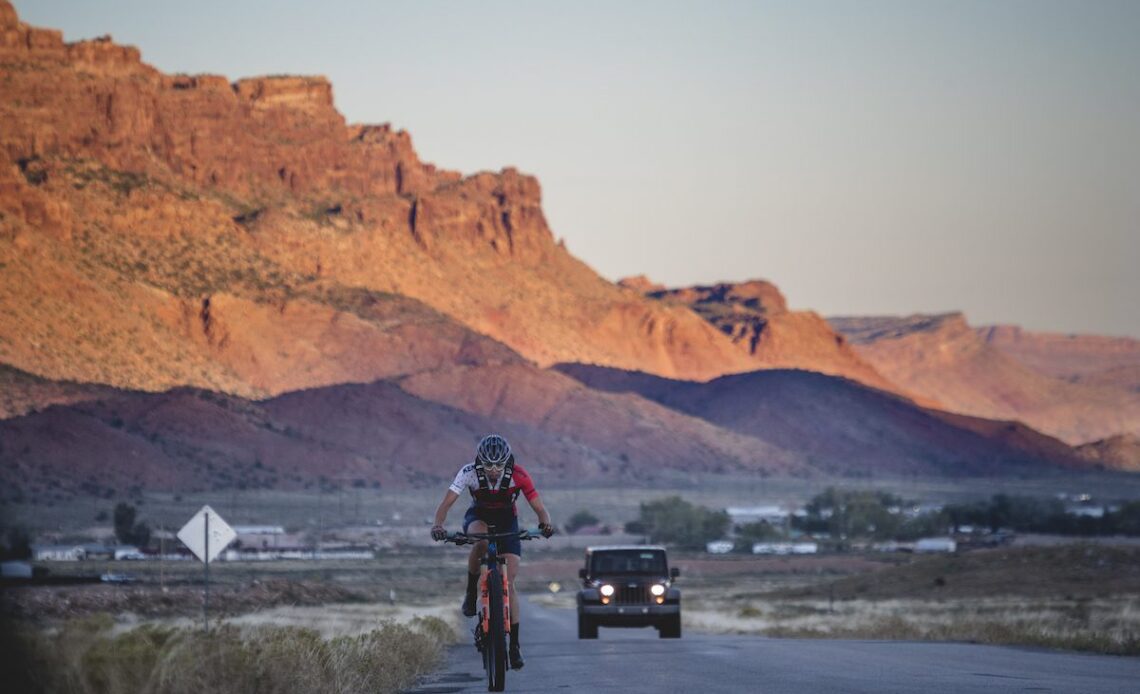 Hannah Otto climbs into the sunrise during The Whole Enchilada FKT ride