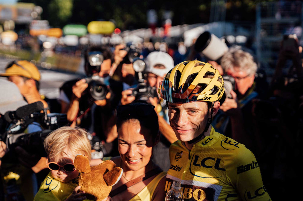 Vingegaard celebrates with his wife and child after the final stage of the 2022 Tour de France