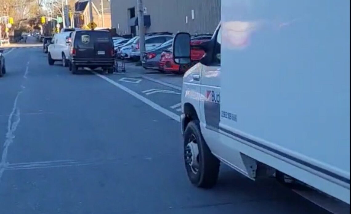 This might be a world record for delivery trucks parked in a Toronto bike lane