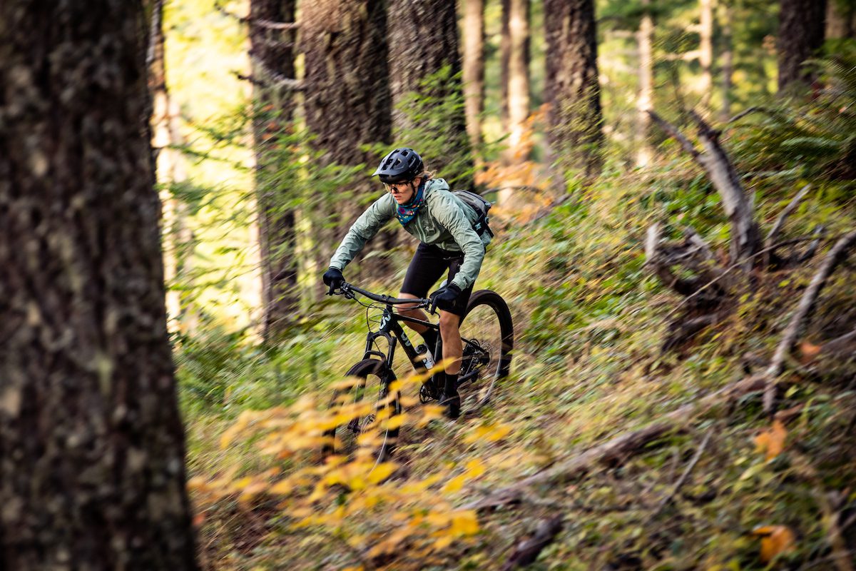A woman riding Liv Lurra trail bike throug the woods 