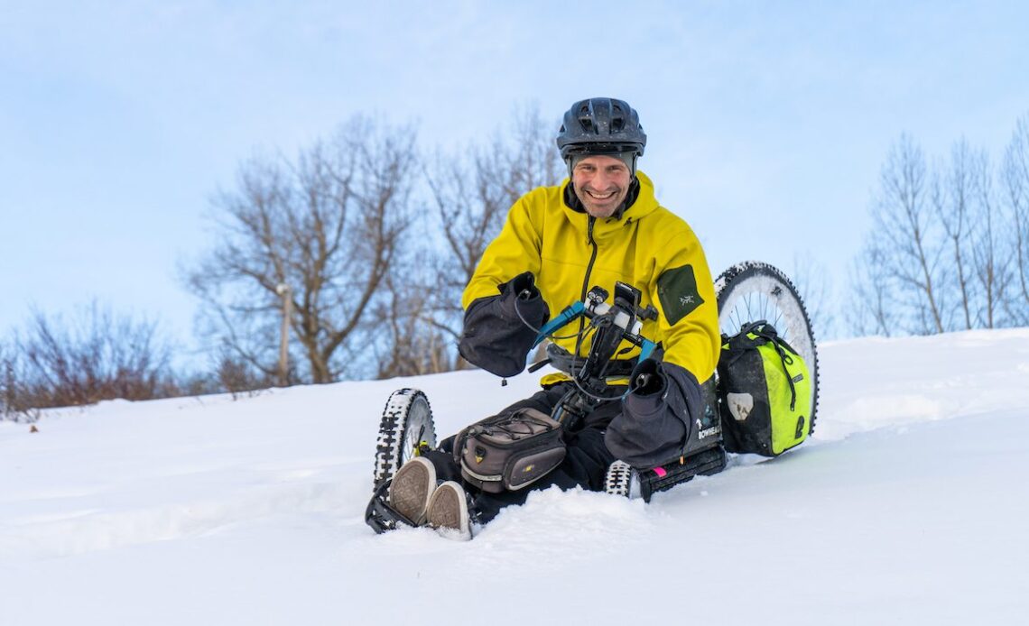 Christian Bagg rides through snow in Calgary, Alta.