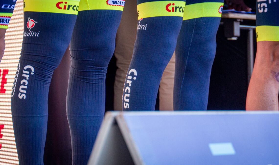 A close-up of the aero leg warmers used by Intermarche-Circus-Wanty as they stand on stage ahead of the race