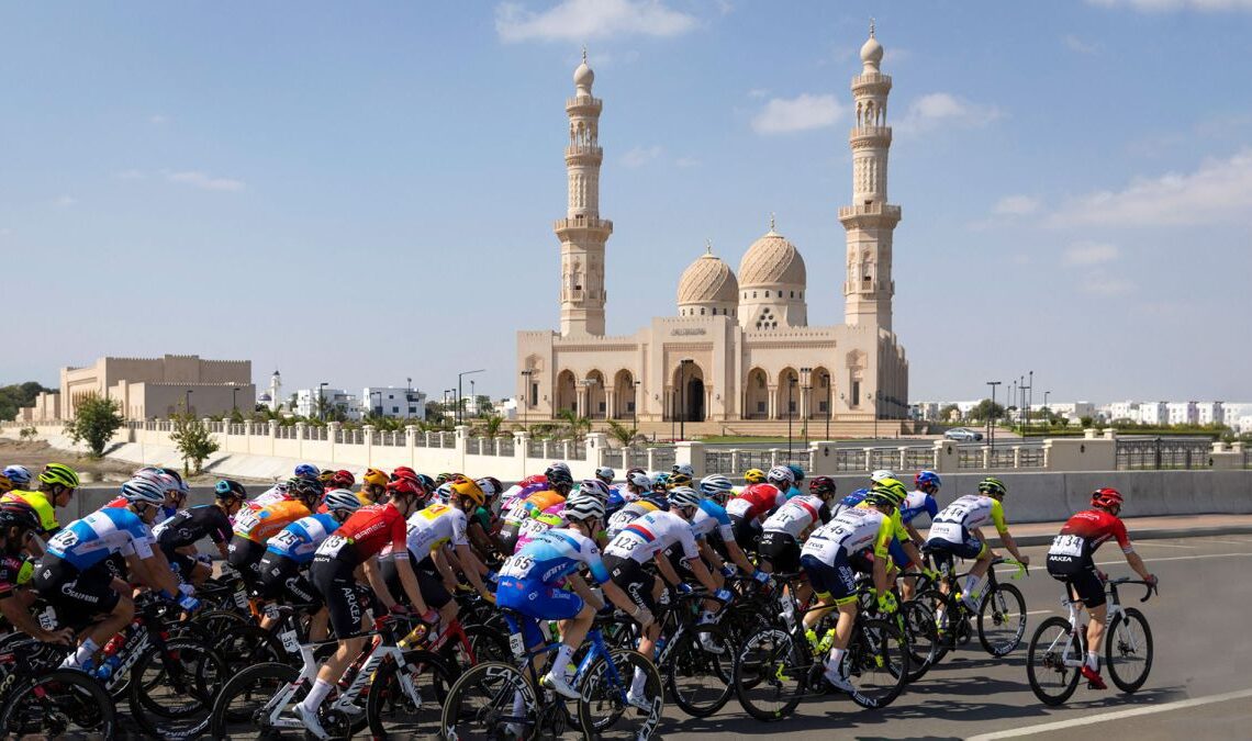 The peloton passes the Sultan Qaboos Grand Mosque in Muscat during stage 6 of the 2022 Tour of Oman Photo by THOMAS SAMSONAFP via Getty Images