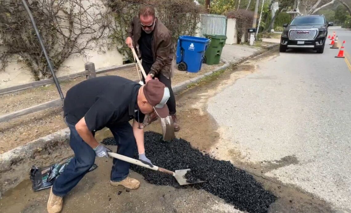 Arnold fixing a pothole