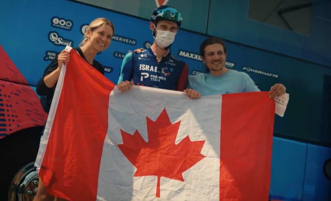 Derek Gee holding a Canadian flag