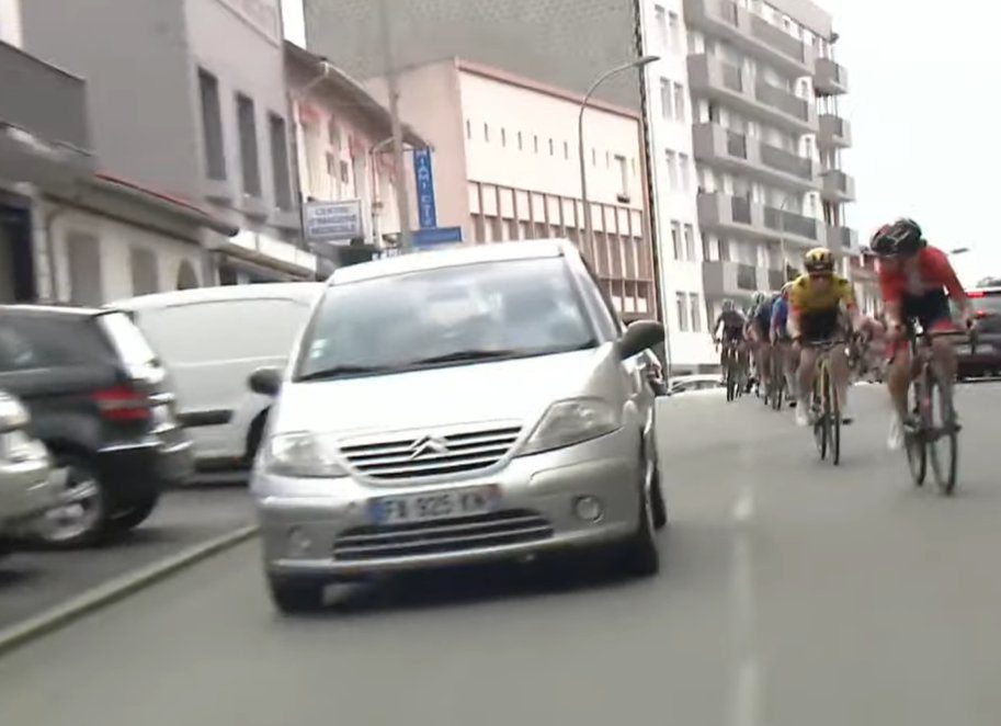 a car blocking a bike race