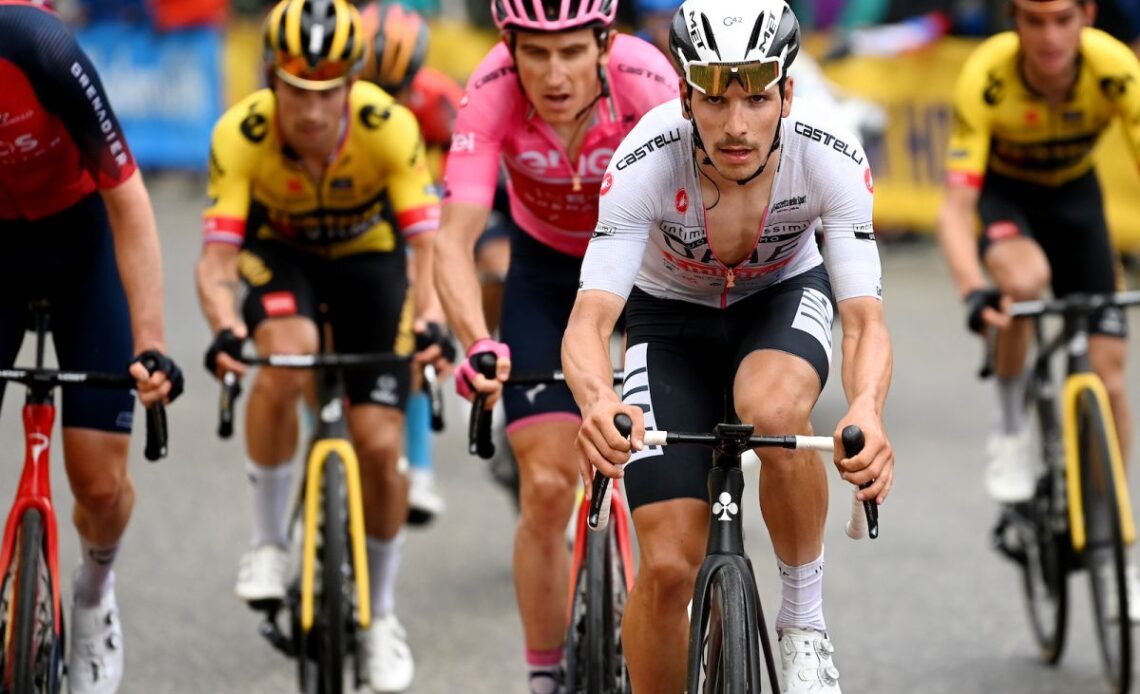 TRE CIME DI LAVAREDO, ITALY - MAY 26: (L-R) PrimoÅ¾ RogliÄ of Slovenia and Team Jumbo-Visma, Geraint Thomas of The United Kingdom and Team INEOS Grenadiers - Pink Leader Jersey and JoÃ£o Almeida of Portugal and UAE Team Emirates - White Best Young Rider Jersey compete while fans cheer during the 106th Giro d