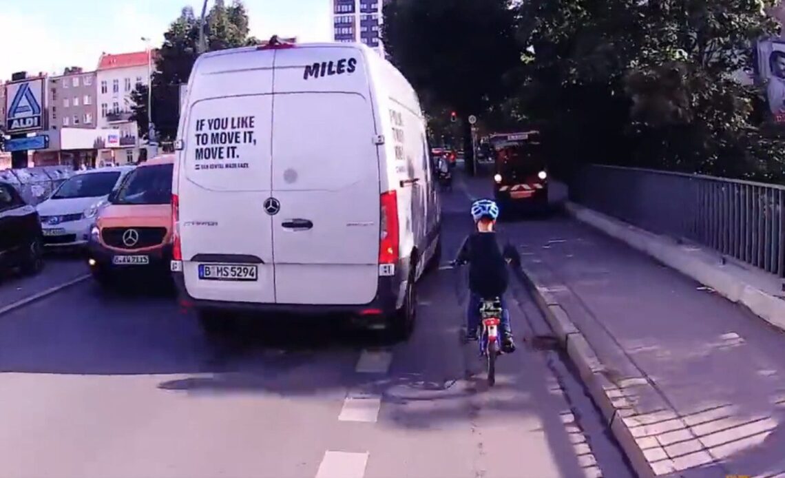 A van comes close to a german kid cycling