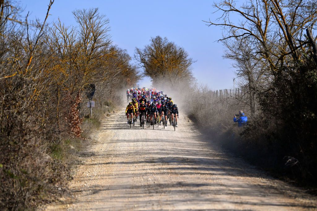 SIENA ITALY MARCH 05 A general view of the peloton passing through gravel roads landscape during the Eroica 8th Strade Bianche 2022 Womens Elite a 136km one day race from Siena to Siena Piazza del Campo 321m StradeBianche on March 05 2022 in Siena Italy Photo by Luc ClaessenGetty Images