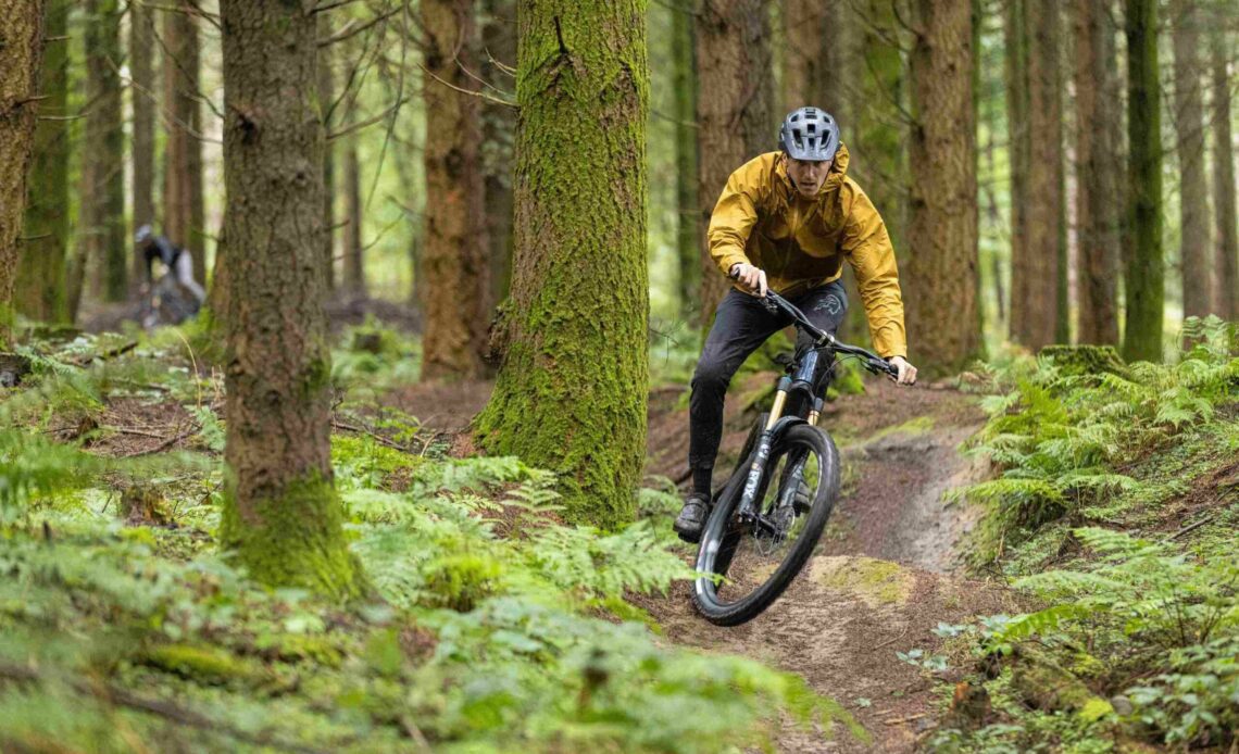 Riding in the Rab Cinder Downpour jacket before a downpour on the YT Jeffsey launch