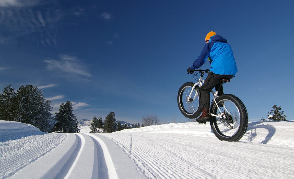 Biking in the snow is super fun on a fat bike. The tires are wide enough so that traction is great, and the tires do not sink into the packed snow of the cross country ski trail.