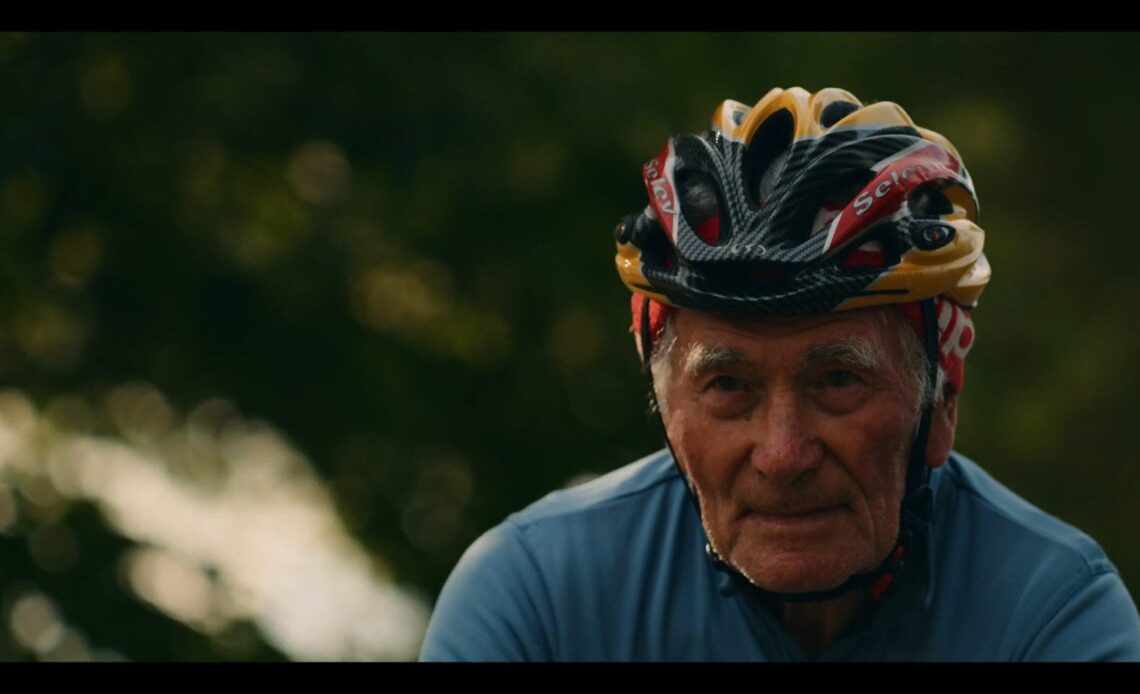 an older man rides his bike