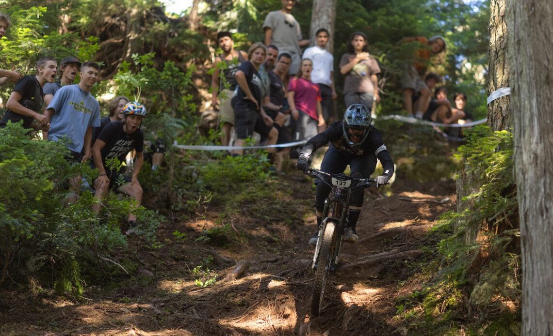 Miranda Miller races by a crowd during the 2022 Canadian Open Enduro during Crankworx