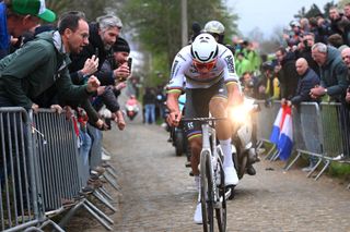 HARELBEKE BELGIUM MARCH 22 Race winner Mathieu van der Poel of The Netherlands and Team Alpecin Deceuninck competes in the breakaway passing through the Oude Kwaremont cobblestones sector while fans cheer during the 67th E3 Saxo Bank Classic Harelbeke 2024 a 2076km one day race from Harelbeke to Harelbeke UCIWT on March 22 2024 in Harelbeke Belgium Photo by Tim de WaeleGetty Images