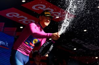 Team Lidl-Trek's Italian rider Jonathan Milan celebrates his best sprinter's cyclamen jersey on the podium of the 6th stage of the 107th Giro d'Italia cycling race, 180 km between Torre del lago Puccini in Viareggio and Rapolano Terme, on May 9, 2024 in Rapolano Terme. (Photo by Luca Bettini / AFP)