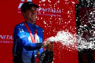 Team Movistar's Spanish rider Pelayo Sanchez celebrates on the podium after winning the 6th stage of the 107th Giro d'Italia cycling race, 180 km between Torre del lago Puccini in Viareggio and Rapolano Terme, on May 9, 2024 in Rapolano Terme. Pelayo Sanchez won the stage ahead of Team Soudal-Quick Step's French rider Julian Alaphilippe and Team Jayco-AlUla's Australian rider Lucas Plapp. (Photo by Luca Bettini / AFP)
