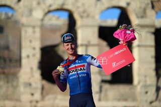 Tim Merlier on the podium after winning stage 21 of the Giro d'Italia 2024