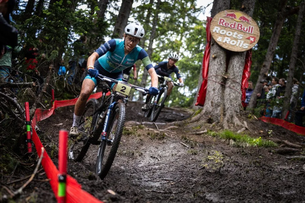 Emilly Johnston greases a muddy section of the Crans-Montana XCC course.