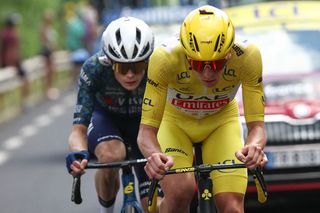 UAE Team Emirates team's Slovenian rider Tadej Pogacar wearing the overall leader's yellow jersey and Team Visma - Lease a Bike team's Danish rider Jonas Vingegaard cycle in the final kilometers of the 11th stage of the 111th edition of the Tour de France cycling race, 211 km between Ãvaux-les-Bains and Le Lioran, in the Massif Central mountains of central France, on July 10, 2024. (Photo by Anne-Christine POUJOULAT / AFP)