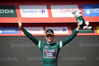 The best sprinter, Team Visma's Wout van Aert celebrates on the podium wearing the green jersey after the stage 6 of La Vuelta a Espana cycling tour, a 185.5 km race between Jerez de la Frontera and Yunquera, on August 22, 2024. (Photo by CRISTINA QUICLER / AFP)