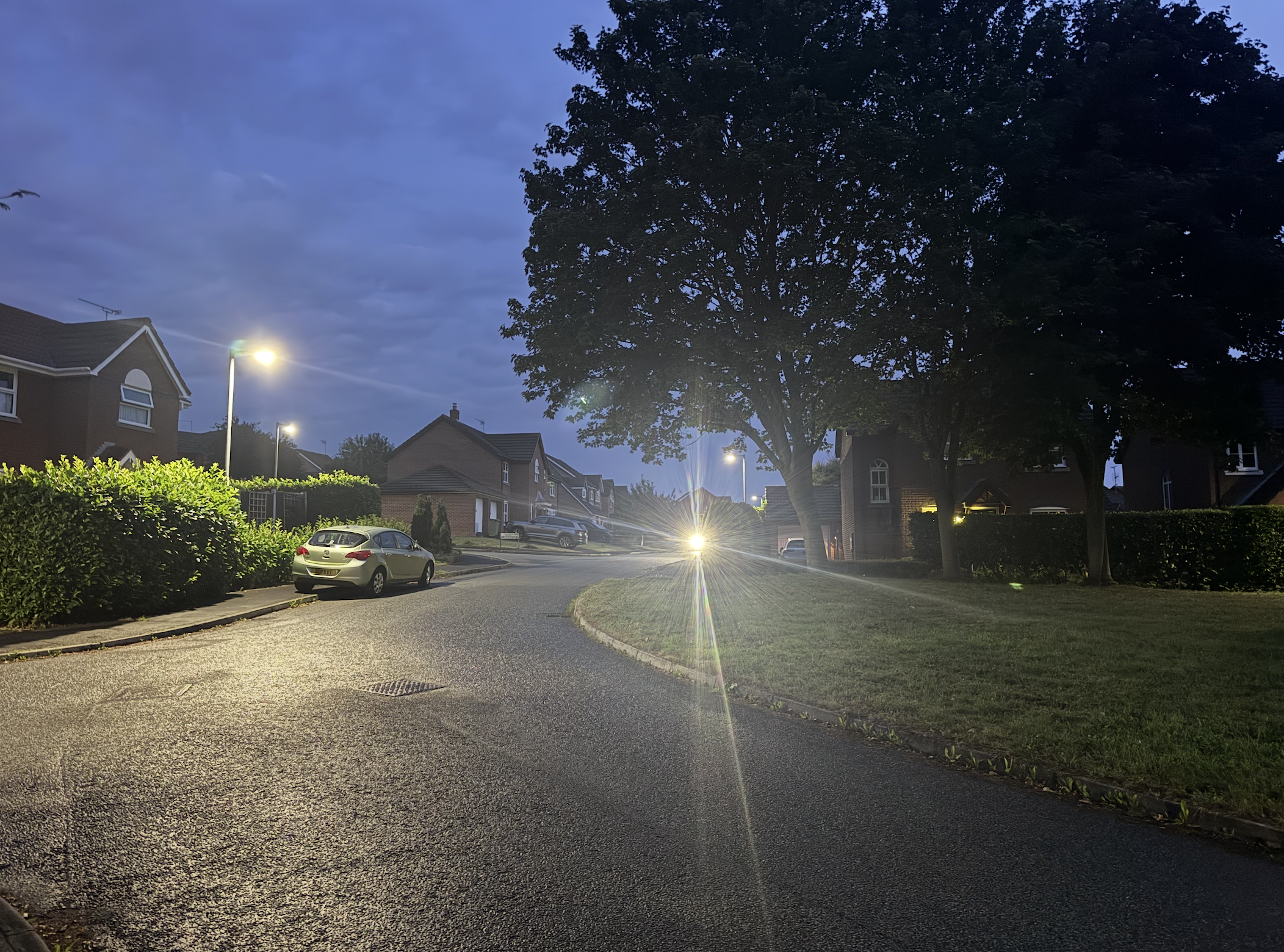 A simple street scene with the glowing orb of the Magic Shine Allty in the distance.