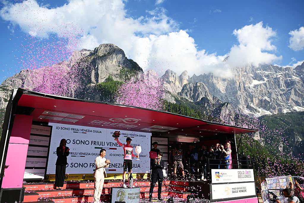 Vingegaard on the podium dwarfed by the Dolomite mountains behind